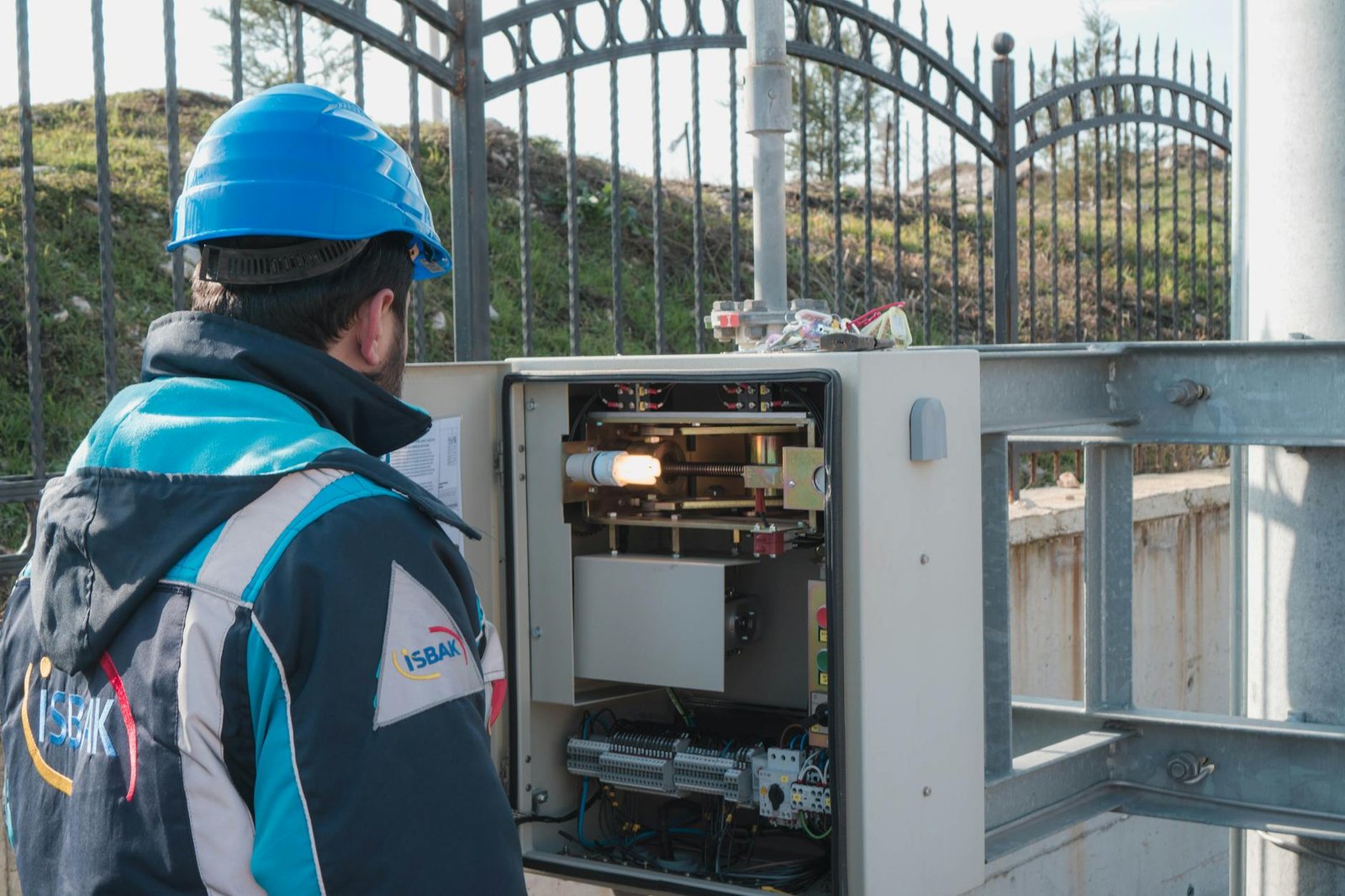 an electrician inspecting a fuse box