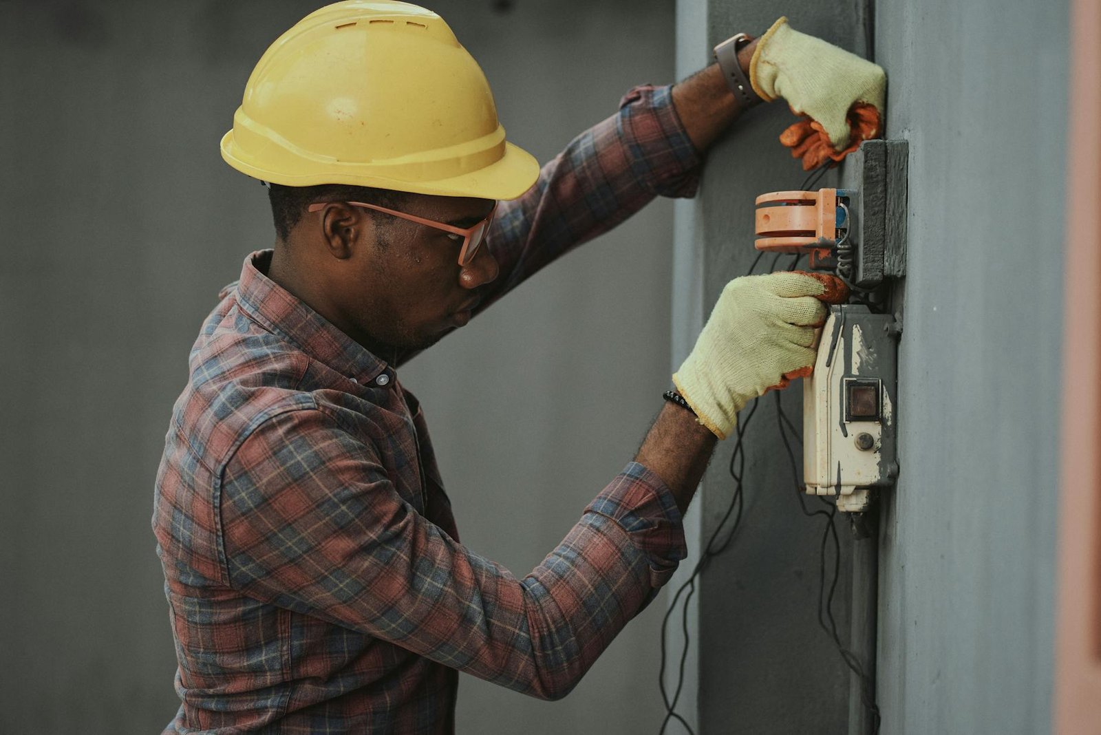 an electrician repairing a fuse box