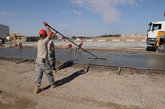 a bull float is being used on drying concrete to smooth c63ee2 640