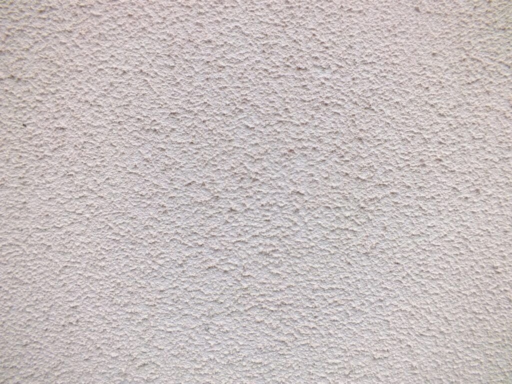 a close up of a white stucco wall